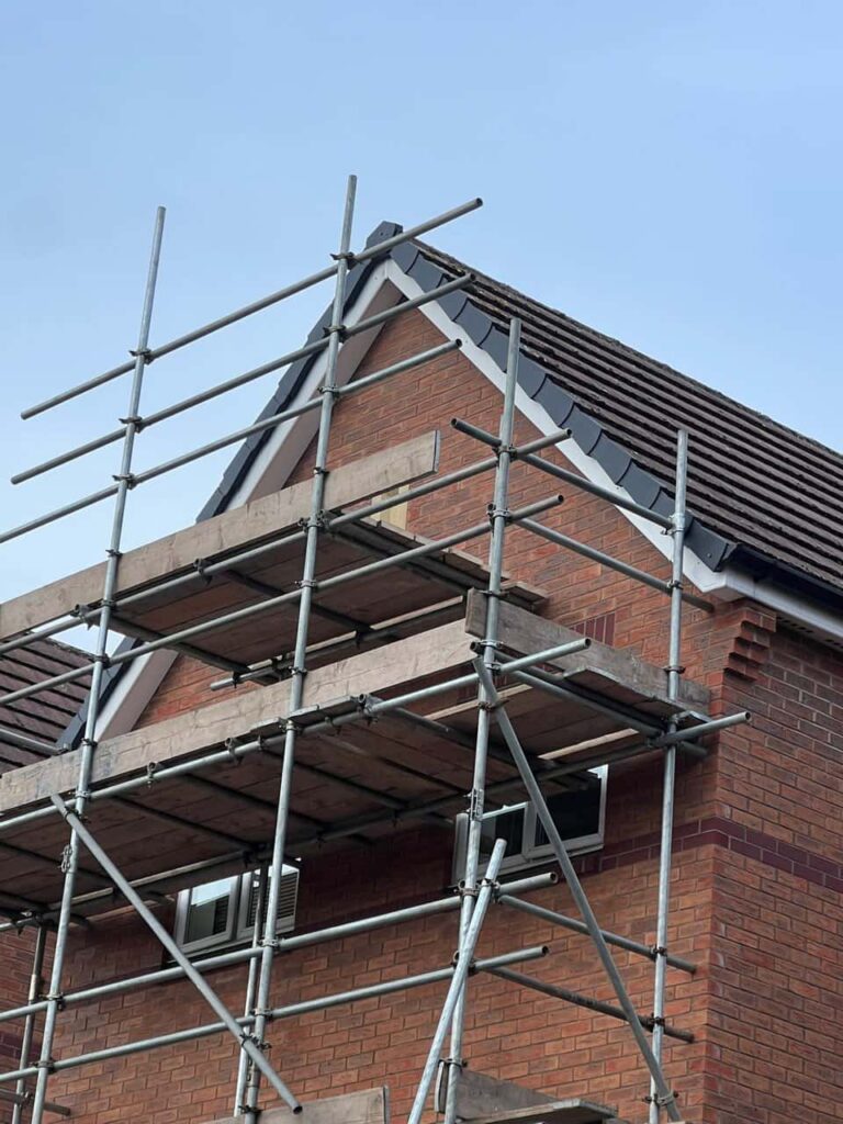 This is a photo of a roof which has just been repaired. There is a scaffold located at the gable end for access onto the roof. Works carried out by LJ Roofing Melksham